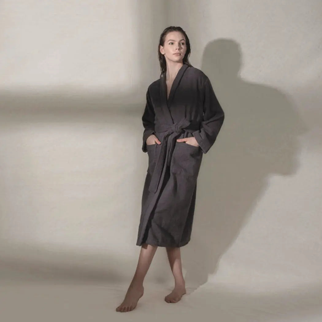 Woman wearing a ribbed textured, anthracite, cotton Summer Forever robe against a neutral background