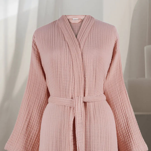 Pink muslin cotton Summer Forever robe with a belt on a neutral background