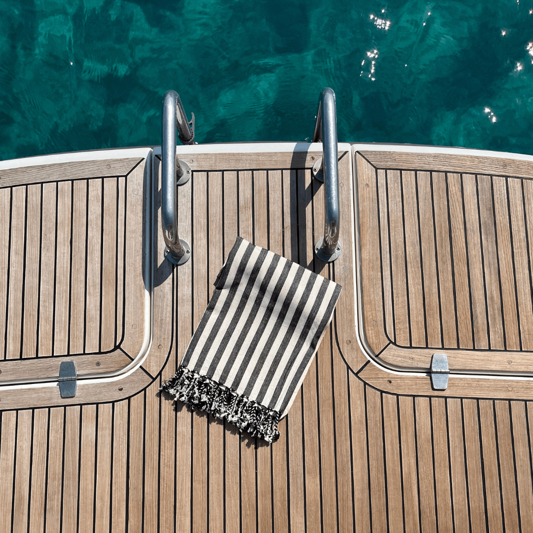 zebra black and white striped turkish beach towel on boat deck