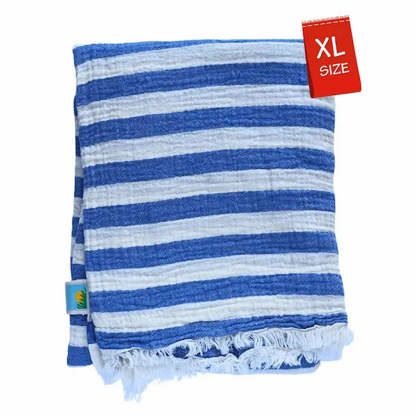 Close-up detail of breathable muslin texture of royal blue and white striped Summer Forever cotton beach towel with an XL size tag on a white background
