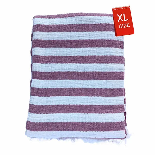 Close-up detail of breathable muslin texture of burgundy and white striped Summer Forever cotton beach towel with an XL size tag on a white background