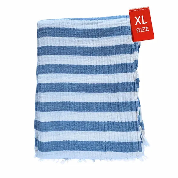 Close-up detail of breathable muslin texture of denim blue and white striped Summer Forever cotton beach towel with an XL size tag on a white background