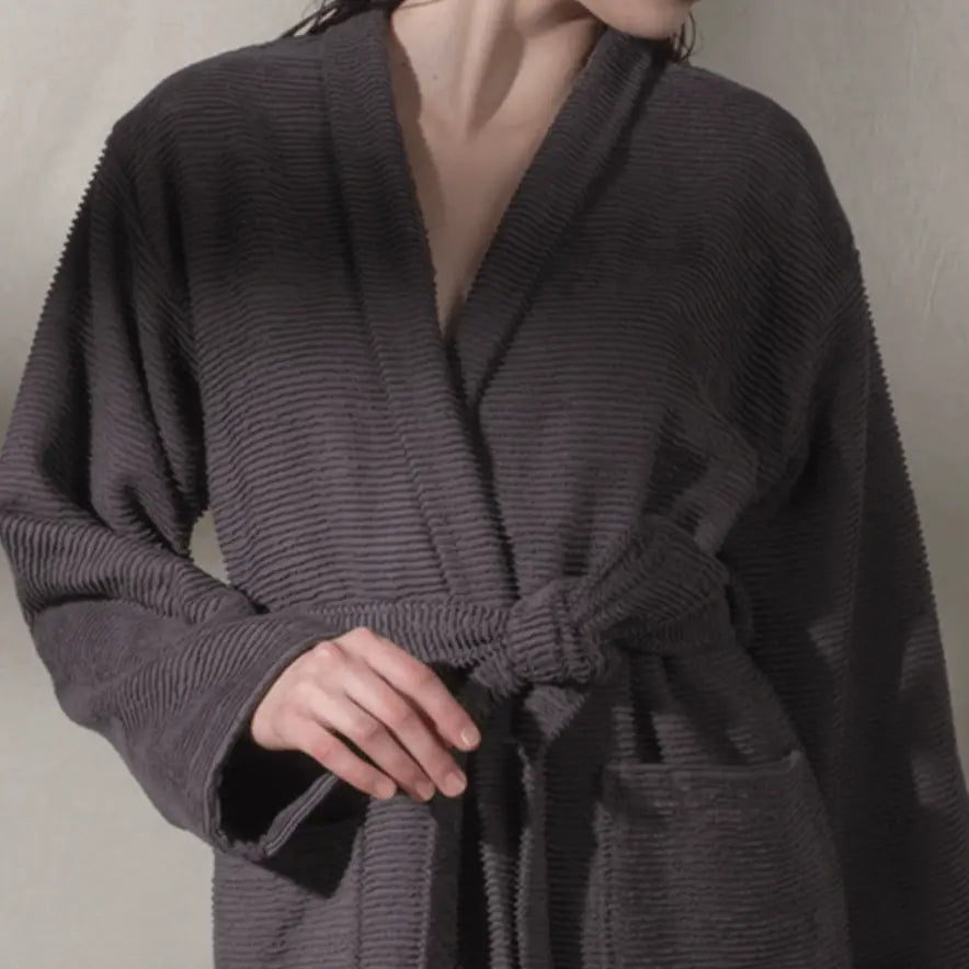 close-up of a person wearing a ribbed textured, anthracite, cotton Summer Forever robe against a neutral background