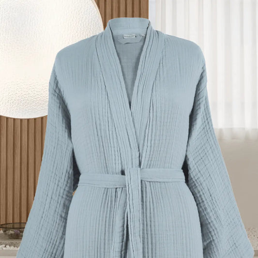 Light blue muslin cotton Summer Forever robe with a belt on a neutral background